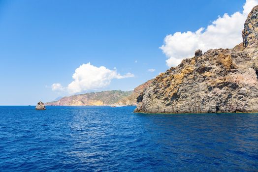 Rocky cliff coast of the Lipari Island seen from the sea, Aeolian Islands, Italy