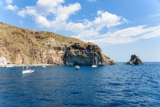 Yachts at the rocky coast of Lipari Island, Aeolian Islands, Italy