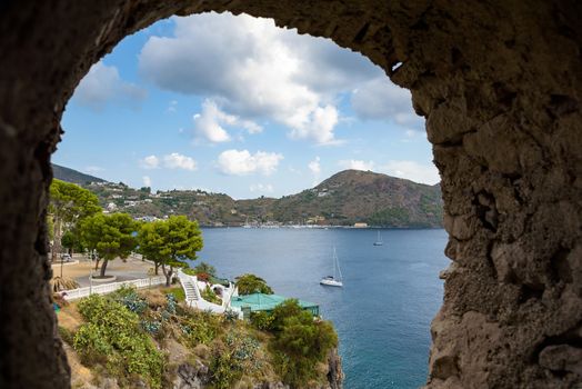 Lipari Island coast seen through the stone window, Aeolian Islands, Italy