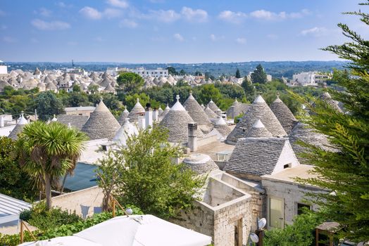 Panoramic view of famous Alberobello town with trulli houses and their conical roofs