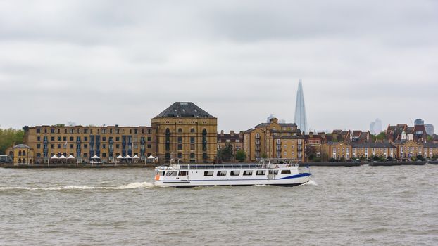 Ship on the River Thames in London's docklands on a cloudy day