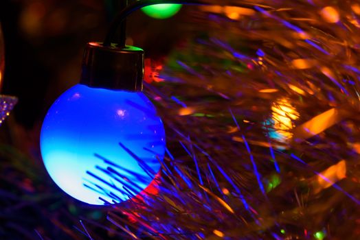 Closeup of blue Christmas tree lamp as background