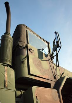 A large military truck, painted in camouflage colors