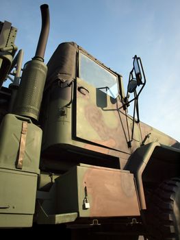 A large army truck, painted in camouflage colors