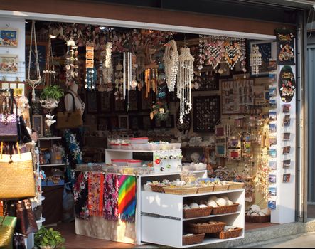 A small store that displays various craft and art products such as things made from shells
