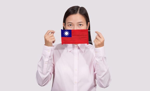 Asian woman wearing hygienic face mask painting Taiwan flag to protect from the Coronavirus 2019 (COVID-19) infection outbreak situation, the virus originated from Wuhan, China.