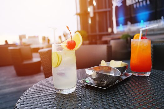 Two iced cocktail glasses in rooftop bar for nightlife