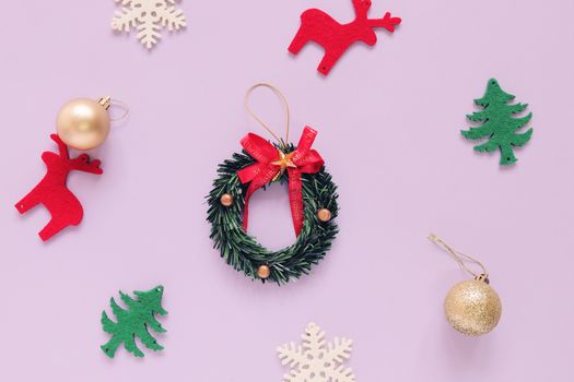 Christmas concept : Flat lay of Christmas ornaments on purple background with minimal style