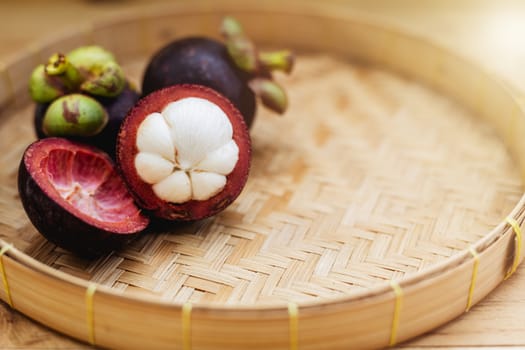 Mangosteen fruit on the wooden tray for food and eating concept
