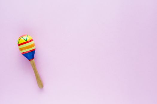 Maracas on pink background for baby toy musical instrument, hobbies, learning and education concept