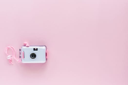Camera waterproof toy on pink background with copy space