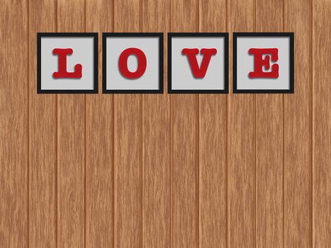 Word "LOVE" in black frame on the wood background