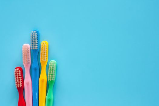 Toothbrush used for cleaning the teeth on blue background for dental care concept