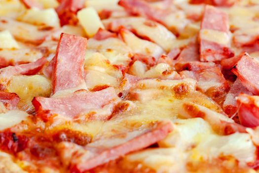 Delicious pizza with pineapple, ham slice, bacon slice, mozzarella cheese, pizza sauce for fast food and ready to eat concept
