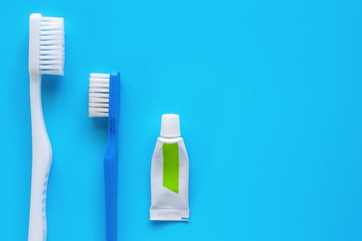 Toothbrush with toothpaste used for cleaning the teeth on blue background for dental care concept