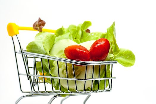 Fresh vegetables in the shopping cart on white background for healthy food concept