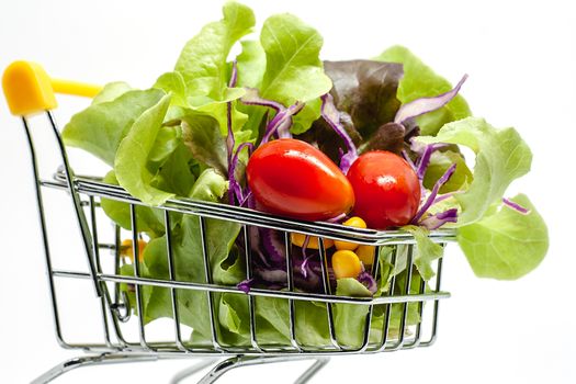 Vegetables in the shopping cart on white background for healthy food concept