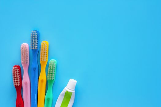 Toothbrush with toothpaste used for cleaning the teeth on blue background for dental care concept