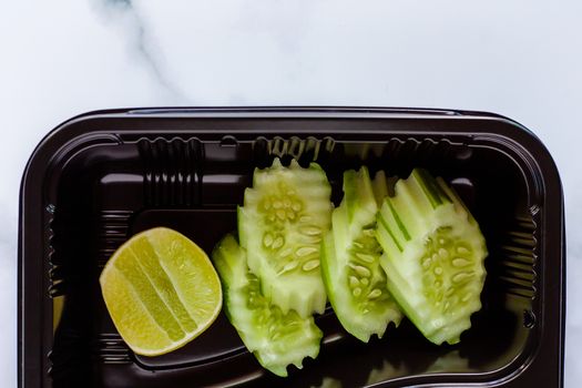 Side dish of vegetables, cucumber and lemon, served with the main meal for food and eating concept