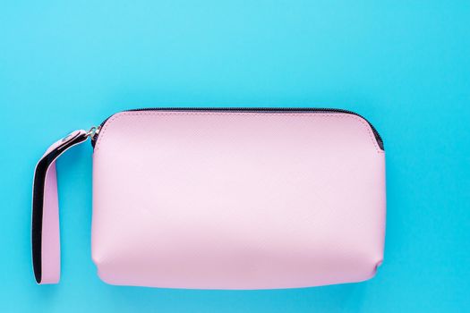 Pink lady leather bag on blue background for cosmetics and beauty concept