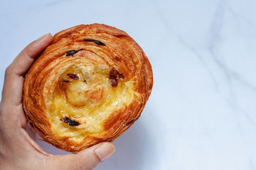 Top view of delicious bread on white marble background for food, bakery and eating concept