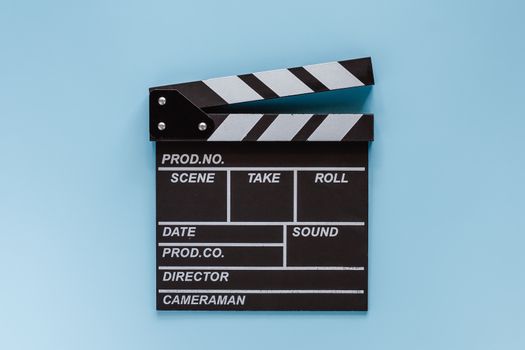 Movie clapper board on blue background for filming equipment