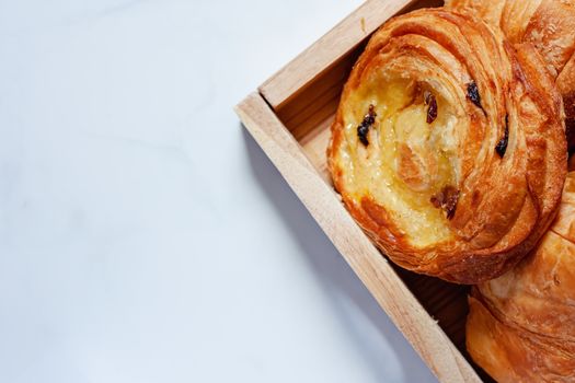 Top view of delicious bread on white marble background for food, bakery and eating concept