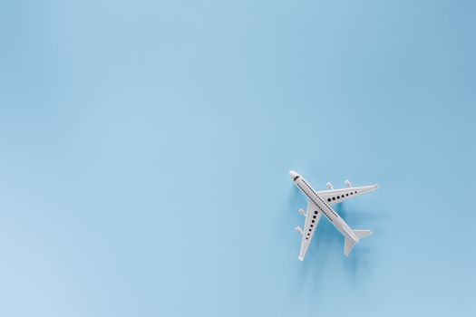 White airplane model on blue background for vehicle and transportation concept