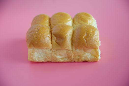 Delicious bread on pink background for food, bakery and eating concept