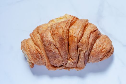 Top view of delicious bread on white marble background for food, bakery and eating concept