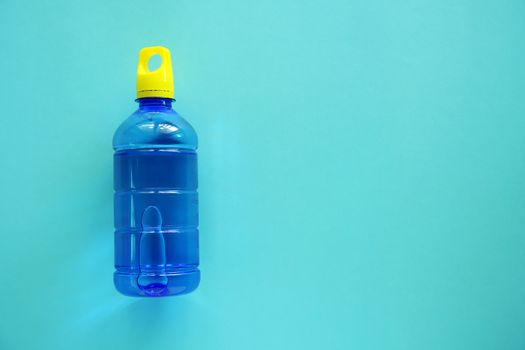 Water bottle on blue background with copy space for healthy drinking concept