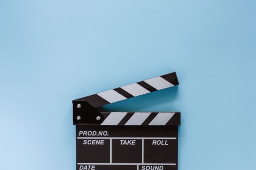 Movie clapper board on blue background for filming equipment