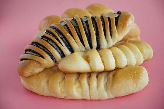 Delicious bread on pink background for food, bakery and eating concept