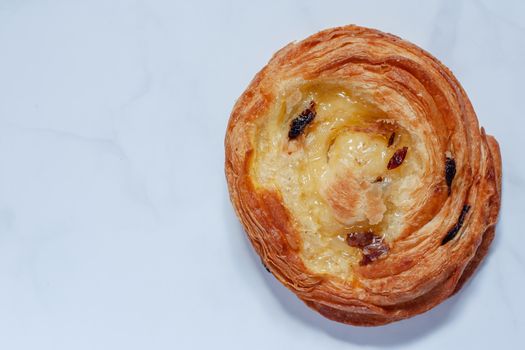 Top view of delicious bread on white marble background for food, bakery and eating concept