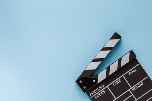 Movie clapper board on blue background for filming equipment