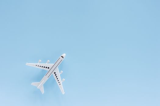 White airplane model on blue background for vehicle and transportation concept