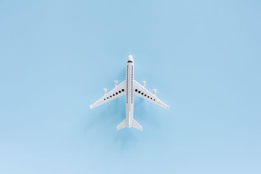 White airplane model on blue background for vehicle and transportation concept