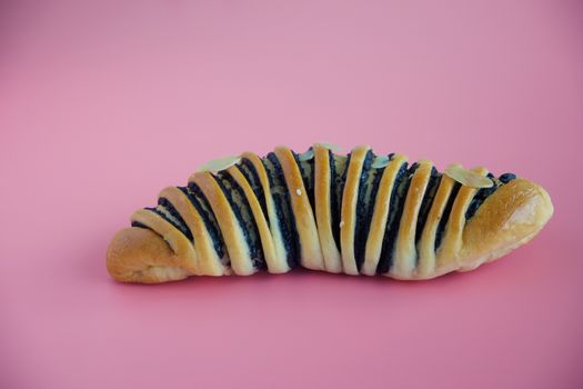 Delicious bread on pink background for food, bakery and eating concept