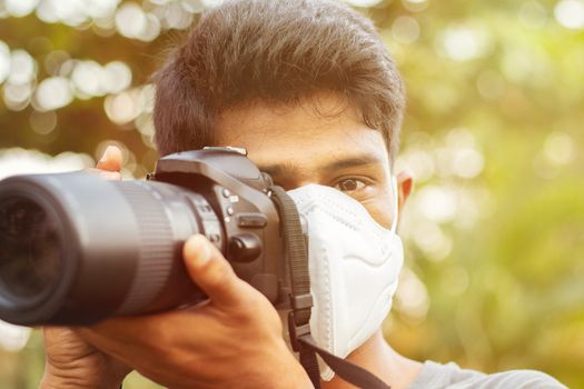Young photographer with Pollution mask - Concept of Photojournalism and its risk