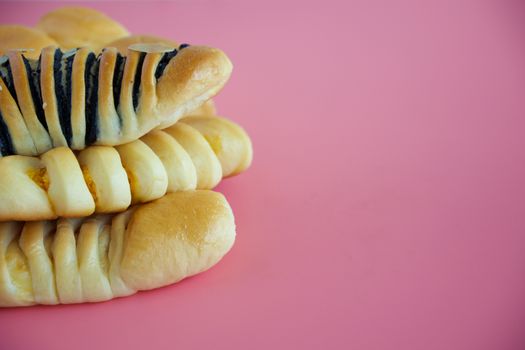 Delicious bread on pink background for food, bakery and eating concept