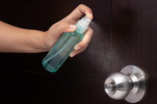 disinfect, sanitize, hygiene care. inject alcohol spray on door knob and frequently touched area for cleaning and disinfection, prevention of germs spreading during infections of COVID-19 coronavirus