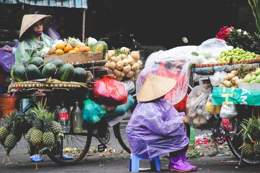 Editorial. A Vietnamese street food vendor selling along the street of Old Quarter in Hanoi Vietnam