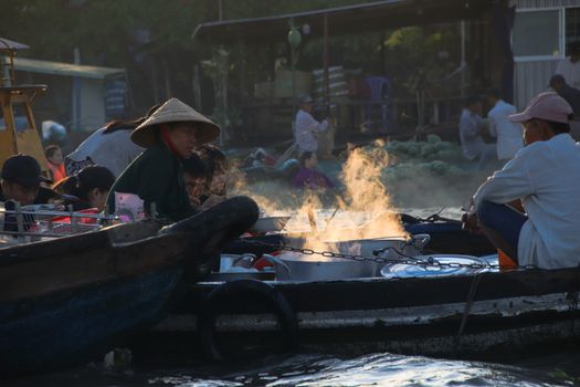 Editorial. Food vendors selling Vietnamese noodle soups in small wooden boats in the famous traditional Cai Rang Floating Market in Can tho, Vietnam
