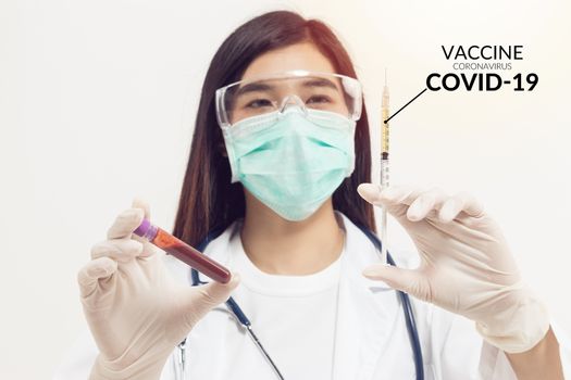 Coronavirus blood sample. Asian doctor holding test tube with blood for covid-19 analyzing. laboratory analyzing for testing and invent drug and vaccine during Coronavirus infection outbreak situation