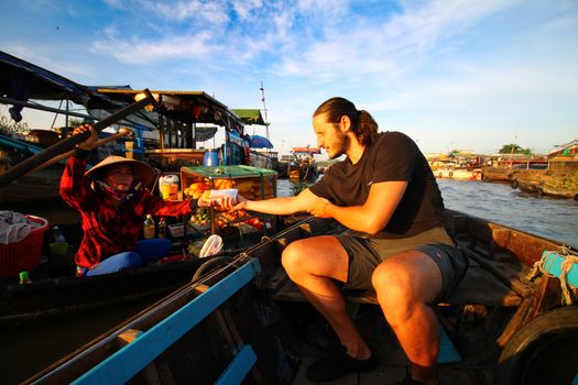 Editorial. Everyday life in Cai Rang Floating Market in Can tho, Vietnam which is a popular tourist destination and considered to be the largest traditional floating market in Asia