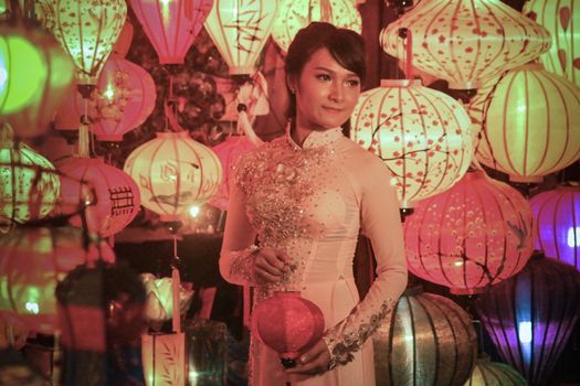 Editorial. A Female Vietnamese tourist posing for a photo among the famous Vietnamese lanterns in Hoi an, Vietnam