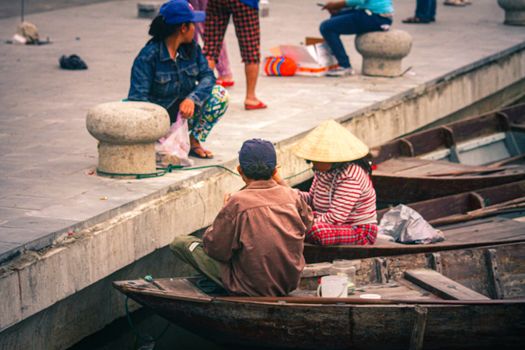 Editorial. Boat tour operators waiting for tourist in the ancient town of Hoi an, Vietnam