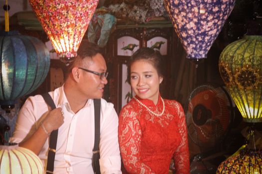Editorial, Vietnamese couple posing for a photo among the traditional lanterns during the Lantern Festival in Hoi an, Vietnam