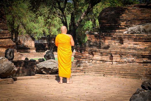 Editorial use only. A Thai Buddhist monk walking around Ayutthaya Historic Park in Ayutthaya, Thailand