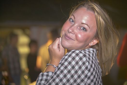 Smiling girl at party, image with blurred background